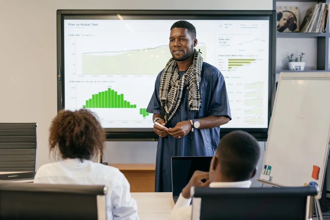 A team member presenting plan-versus-actual figures to colleagues